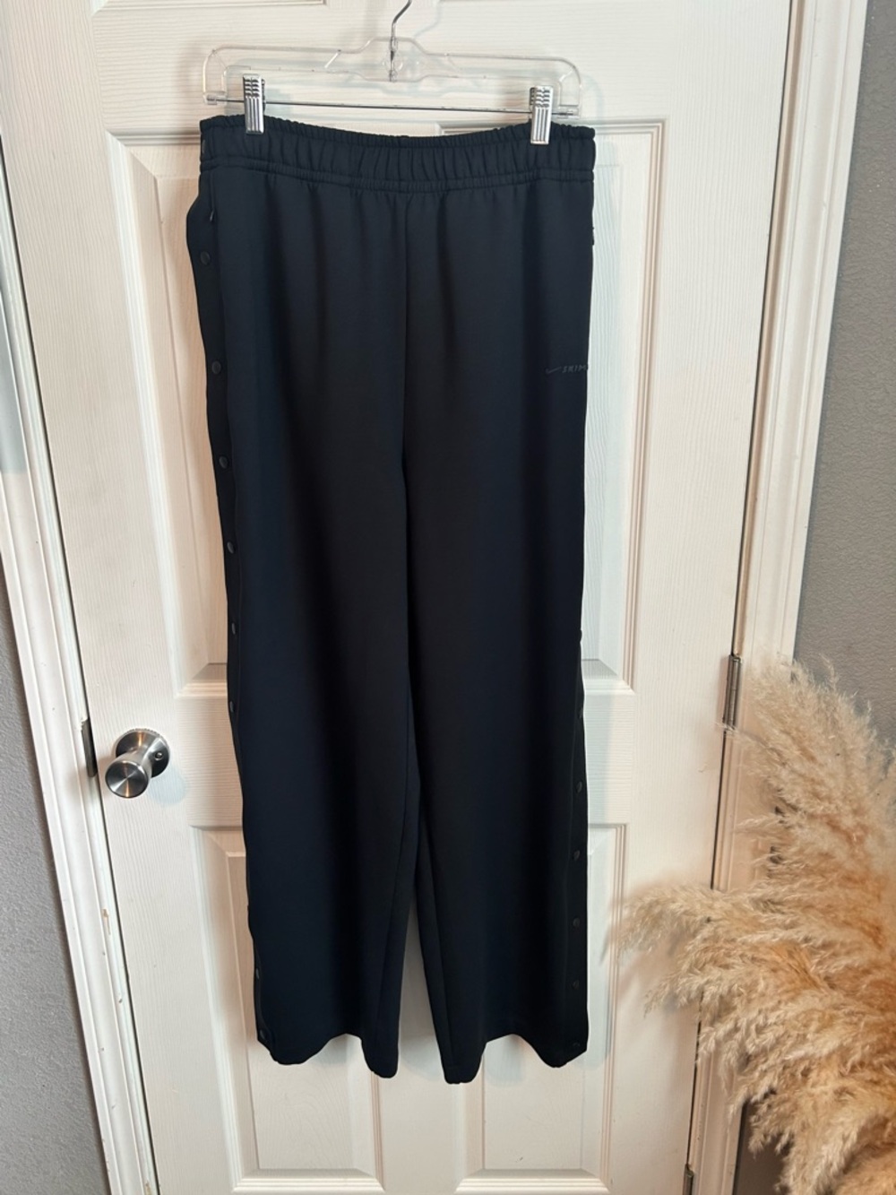 Women’s SKIMS x Nike snap button track pants